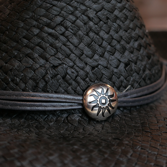 black straw cowboy hat features a sun charm
